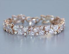 "Introducing 'Sydney', a dazzling rose gold crystal bracelet which you'll want to wear many years into your wedded bliss. Beautiful cubic zircon teardrop and round crystals are set in a tarnish-free base for a refined bridal accessory which will have all eyes on you as you raise your glass or dance the night away. Co-ordinating necklace and earrings showing in photos 3 & 4. Listing is for bracelet only. ❣ Features AAA quality cubic zircons. ❣ Length is 7\" with an optional 1.5\" extender. ❣ Elegant Sparkling Rose Gold Bracelet, Elegant Rose Gold Crystal Bracelets, Sparkling Diamond Bracelets In Rose Gold, Rose Gold Crystal Bracelet With Sparkling Stones For Wedding, Dazzling Rose Gold Bracelets With Sparkling Stones, Formal Sparkling Rose Gold Bracelets, Sparkling Rose Gold Anniversary Bracelets, Adjustable Rose Gold Tennis Bracelet For Wedding, Rose Gold Diamond Bracelet For Party