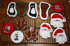 decorated cookies on a cooling rack with pictures and santa hats