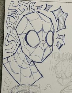 a drawing of a spiderman head on top of a piece of paper