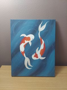 an acrylic painting of two koi fish swimming in the blue water with white and orange tails