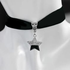 Make a statement with this beautiful handmade choker necklace featuring a half black, half rhinestone star pendant. Perfect for those who love all things Gothic and space-themed. Adjustable velvet strap with a lobster closure for easy wear. Ideal for special occasions like weddings, graduations, and anniversaries. #chokernecklace #gothicstyle #spacethemed #starnecklace #handmadejewelry #statementpiece 🌟🖤✨ #chokerjewelry #chokernecklace #jewelryshop #jewelrylovers #jewelrystore #cutechokers Silver Star-shaped Choker For Party, Elegant Star-shaped Crystal Jewelry, Punk Star-shaped Necklace For Parties, Metal Star Charm Jewelry For Party, Star-shaped Rhinestone Jewelry, Black Star Charm Choker Necklace, Black Crystal Pendant Necklace, Black Rhinestone Choker Jewelry, Black Jewelry With Rhinestones As A Gift