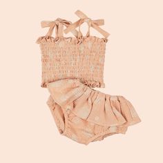 A light pink two piece set for kids with a pair of ruffle bloomers and a smocked top with tie shoulder strap details and a seashell print. Seashell Pink, Seashell Print, Baby Bundles, Smocked Top, Ruffled Skirt, One Summer, Custom Drawing, Pink Sand, Summer Adventures