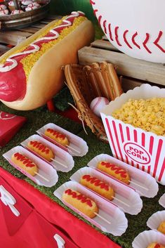 hotdogs and corn on a table at a baseball themed birthday party with popcorn