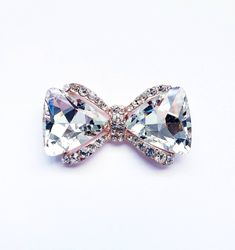 Add a wonderful finishing touch to your look when you wear one of our crystal brooches. This bow will brighten up any outfit and add a sweet accent to your style. This rhodium plated, alloy, ribbon brooch pin is so amazing that you will want to wear it with everything. Pin it on the lapel of your favorite blazer, wear it on a tee shirt or pin it on a scarf or a fabric purse for a completely unique look every time. Consider adding this beautifully designed pin to any of your wedding accessories t Sunflower Accessories, Ribbon Brooch, Fabric Purse, Flower Lapel Pin, Bow Brooch, Retro Accessories, Collar Chain, Fabric Purses, Gold Brooches