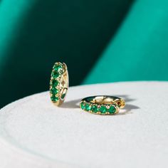 Fall in love with these beautifully crafted hoop earrings. Complete with gold and emerald green crystal, these earrings will be a go-to for years to come. Gold-plated Sterling silver Emerald green crystal Size: 0.6in x 0.6in Hypoallergenic, lead & nickel free If you aren't in LOVE with your purchase, please let us know within 30 days of receiving your item, and you'll receive a stress-free refund. Green Jewellery Set, Green Hoop Earrings, Green Jewellery, Earth Jewelry, Gold And Emerald, Om Bracelet, Emerald Green Crystal, Huggie Earrings Gold, Emerald Green Earrings