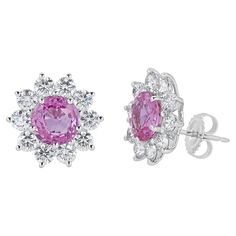 Stud earrings contain 2 finely matched round brilliant cut pink sapphires, 5.08tcw.. Surrounding pink sapphires are round brilliant diamonds creating a halo, totaling 3.08tcw. Diamonds are near colorless and VS2 in clarity, excellent cut. Stones are mounted in a handmade 18K prong setting with a pushback post closure. Total earring measure approximately 16x16mm in total. All of our pieces are packaged carefully and accompanied by a Pico box to keep your jewelry item safe. A complimentary apprais Halo Earrings Studs, Gold Halo, Flower Tops, Brilliant Diamond, Sapphire Diamond, Pink Sapphire, Halo Diamond, Diamond White, Prong Setting