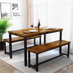 a dining table with two benches next to a potted plant and wine glass on the table