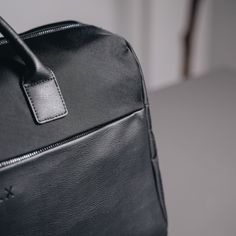 Designed to be minimal and understated, we've made a bag perfect for everyday use. Our minimalist holdall has an outer zip pocket, a grab handle, three inside pockets, and a leather shoulder strap, as well as a magnetic slot for easy access to your belongings. 47cm x 22cm x 27cm (can be used as carry-on luggage). Water-resistant. 28-litre capacity. Includes detachable shoulder strap. Outer zip pocket perfect for accessories. Two open inside pockets and one inside zipped pocket. Made from vegan l Packable Rectangular Shoulder Bag For On-the-go, Modern Travel Bag With Anti-theft Pocket For Daily Use, Eco-friendly Black Shoulder Bag With Double Handle, Outdoor Travel Bag With Leather Handles, Rectangular, Modern Black Travel Bag With Anti-theft Pocket, Free Notebook, Gunmetal Grey, Carry On Luggage, A Bag