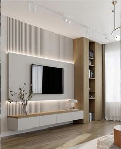 modern living room with white walls and wooden flooring, large television on the wall