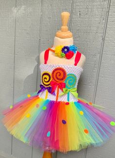 a dress made out of tulle with candy and lollipops on it