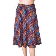 True vintage pleated plaid full wool skirt Made by ILGWU Int Ladies Garment Union  AFL-CIO According to the label the skirt is made between 1974 to 1995- most probably in the 70s Size zipper fastening. Colors- blue, red burgundy, orange, beige and brown stripes. Size 9-10, corresponds size S or M. Please see the measurements and decide before you buy. Measurements /flat/ - waist 27''/68cm hip - full length 25.5''/65cm Preowned in great condition. No holes or rips, no stains. Please see pictures Vintage Plaid Pleated Skirt, Retro Plaid Knee-length Skirt, Retro Pleated Bottoms For Fall, Retro Knee-length Plaid Skirt, Vintage Plaid Full Skirt, Retro Plaid Flared Skirt, Retro Plaid Full Skirt, Vintage Plaid Pleated Skirt For Fall, Retro Full Plaid Skirt