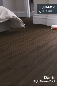 an image of a bedroom with wood flooring