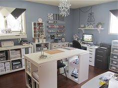 a home office with lots of drawers and shelves on the wall, along with a chandelier hanging from the ceiling