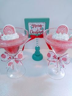 two martini glasses filled with whipped cream and candy canes