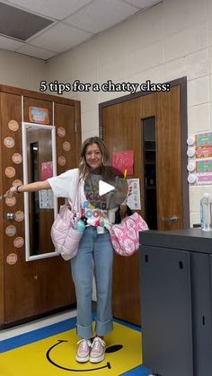 a girl is standing in front of lockers and holding her hand out to the side