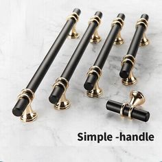 six black and gold door handles on a marble surface with the words simple - handle