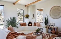 a living room filled with furniture and a fire place in the middle of a room