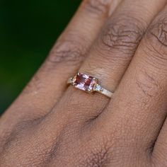 This unique zircon and champagne diamond ring is perfect for those who want a twist on a classic style. The radiant cut pink zircon measures 6.9x4.8mm and has a gorgeous rose color with some orange tones. It's free from any visible inclusions to the naked eye, and it looks amazing set in recycled 14k yellow gold. If you're looking for something a little bit special, this ring is definitely it! Center Stone Details: Gemstone: Zircon Hardness: 7.5/10, great for everyday wear but be cautious Origin Baguette Cut Tourmaline Jewelry For Weddings, Radiant Cut Morganite Wedding Jewelry, Wedding Rings With Baguette Cut Tourmaline, Baguette Cut Tourmaline Wedding Ring, Baguette Cut Ring With Side Stones As Gift, Baguette Cut Rings With Side Stones For Gift, Baguette Cut Jewelry With Side Stones As Gift, Baguette Cut Jewelry With Side Stones For Gift, Gift Baguette Cut Jewelry With Side Stones