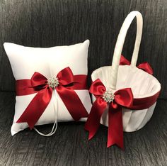 two white baskets with red bows on them