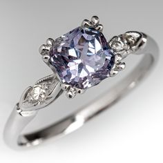 This pretty engagement ring features a no heat Tanzania origin violet sapphire that we sourced and set in an elegant vintage platinum diamond mounting. This ring is currently a size 7.25. Classic Sapphire Rings In Purple, Classic Purple Sapphire Ring For Wedding, Elegant Platinum Amethyst Ring For Wedding, Classic Purple Sapphire Wedding Ring, Elegant Platinum Amethyst Wedding Ring, Lavender Brilliant Cut Rings For Formal Events, Brilliant Cut Amethyst Ring In Platinum For Anniversary, Purple Sapphire Vintage Ring For Anniversary, Tanzanite Diamond Ring With Diamond Accents For Wedding