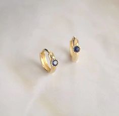 Simple and comfort natural blue sapphire, beaded bezel set huggie hoop earrings made in 14K solid gold * Metal: 14kK Solid Gold * Earring inner diameter: 6.5mm * Stone size: 3mm natural dark blue sapphire * Sold as Single or A Pair * Stamp: 14K * Guaranteed Authentic Solid Gold, Not Plated or Filled ❤️Visit our official website for exclusive new products.      https://elekalonjewelry.com/ ❤️Follow us on Instagram @ elekalonjewelry for the latest projects and much more! ❤️If you have any questions, please feel free to message us. Tiny Hoop Earrings, Cartilage Hoop, Cartilage Earrings Hoop, Helix Earrings, Solid Gold Earrings, Natural Blue Sapphire, Huggie Hoop Earrings, Natural Sapphire, Something Blue