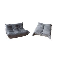 two grey cushions sitting next to each other