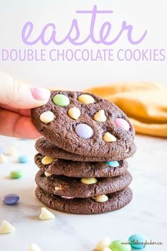 a stack of chocolate cookies with m & m's on top and the text overlay reads, easter double chocolate cookies