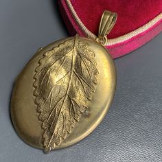 Large Old ~ gold filled ~ photo locket /pendant for necklace ~ featuring a large textured leaf on front side , back is plain ~ Locket opens to reveal two compartments for photos , original fitter ring still intact ~ Unmarked gold filled ( tested ) . Most likely dates 1920's (could be but earlier ) Materials : Gold filled Measures : Locket is 2 inches (top bale included ) in drop length x 1 1/4 inches max width. Weighs 15 grams on my weighing scale . Condition : Considering the age locket is in g Vintage Gold Leaf Jewelry, Vintage Gold Leaf-shaped Jewelry, Victorian Photos, Photo Pendant, Victorian Gold, Weighing Scale, Photo Locket, Hinged Bangle, Locket Necklace