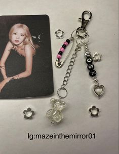 a keychain with two charms attached to it and a photo on the back