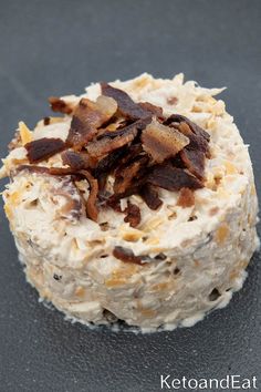 a close up of a cake with bacon on top and frosting in the middle