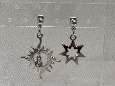 Crafted with a touch of celestial charm, these silver mismatched dangle earrings are a whimsical addition to your jewelry collection. One earring features a radiant sun charm, while the other showcases a delicate star, adding a playful asymmetry to your look. The intricate details of each charm catch the light beautifully, bringing a subtle sparkle to your ensemble. Perfect for everyday wear or a special occasion, these earrings effortlessly blend fun and elegance. Embrace the uniqueness of these mismatched earrings and let your style shine bright like the stars. Celestial Silver Earrings With Star Charm, Silver Star Earrings With Charms, Trendy Silver Earrings With Charms, Celestial Silver Earrings With Dangling Charms, Silver Celestial Earrings With Dangling Charms, Sun Charm, Mismatched Earrings, Celestial Jewelry, Etsy Earrings Dangle