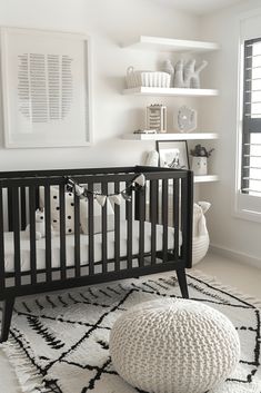 a black and white baby's crib in a room with bookshelves