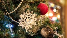 a christmas tree with ornaments and lights in the background