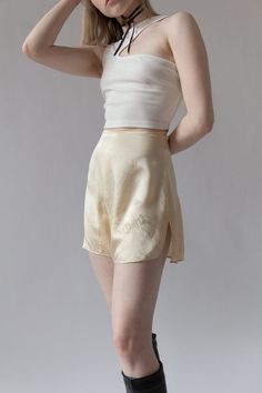 "Bridal silk tap shorts for \"Chippy\" from Bergdorf Goodman in the 1920s. Complete with custom embroidery and tiny mother of pearl buttons at side. The softest cream silk. Very wearable for today and in excellent shape. BRAND / Bergdorf Goodman MATERIAL / 100% Silk CONDITION / Some minor discolorations on back but overall in excellent shape for their age. SIZE / US 0 MEASUREMENTS / Waist - 24\" / Hip - 36\" Nicolette is a size 24 and 5'3" Elegant Fitted Shorts For Loungewear, Summer Silk Cream Bottoms, Cream Silk Bottoms For Summer, Summer Cream Silk Bottoms, Silk Bottoms For Summer Daywear, Summer Silk Bottoms For Daywear, Fitted Silk Bottoms Short Length, Fitted Silk Cream Bottoms, Chic Silk Shorts