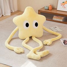 an octopus stuffed animal sitting on top of a rug