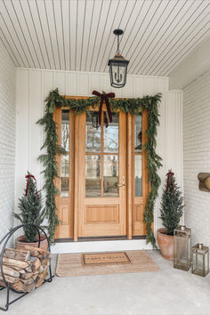 Front door views, holiday home, seasonal finds, front door refresh, faux garland, faux tree, velvet ribbon, neutral home, aesthetic home, doormat finds, Christmas entry, Amazon, Target, William-Sonoma, holiday finds, creamy whites, warm woods, neutral Christmas vibes, warm and cozy, Target Christmas style, Amazon Christmas, holiday front entry look, lighting detail, red velvet detail, light and bright, neutral front entry, cozy winter vibes Christmas Porch Double Doors, White House With Christmas Wreaths, White House Christmas Decorations Exterior, Exterior Wreaths Christmas, Christmas Wreaths For Double Front Door, Christmas Lights On House Exterior Farmhouse, Double Door Wreath Ideas Christmas, Christmas Double Door Decor, Wreaths Outside Windows