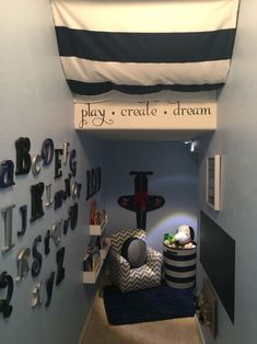 there is a play room with blue walls and black and white decor on the wall