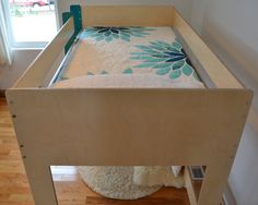 a baby crib with a mattress on top of it and a rug underneath the bed