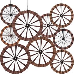 several circular objects hanging from strings in the shape of spokes on a white background