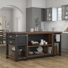 a kitchen island with pots and pans on it in front of a dining room table