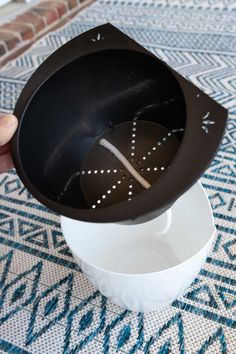 a black and white clock sitting on top of a table