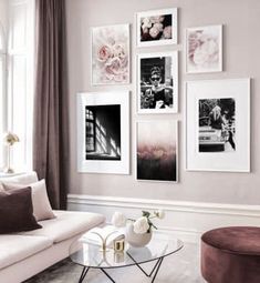 a living room with pictures on the wall and a coffee table in front of it