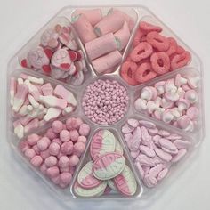 a tray filled with lots of candy and candies on top of a white table