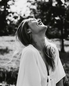 black and white photograph of a woman with her eyes closed, looking up to the sky