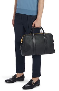 Smooth-leather straps highlight the natural grain of this spacious duffle bag perfect for weekend getaways or business travel. Two-way top-zip closure Top carry handles; removable, adjustable shoulder strap Interior zip pocket Structured silhouette with flat base and protective metal feet Leather Made in Italy Top Handle Bag With Gold-tone Hardware For Business Trips, Black Bags With Gold-tone Hardware For Business Trips, Formal Weekender Satchel Bag With Leather Lining, Formal Weekender Bag With Leather Lining And Satchel Shape, Leather Briefcase With Gold-tone Hardware For Business Trips, Business Leather-lined Shoulder Duffle Bag, Designer Business Duffle Bag With Leather Trim, Designer Duffle Bag With Leather Trim For Business, Business Shoulder Bag With Gold-tone Hardware And Top Handle