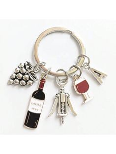 a bottle of wine and some charms on a keychain