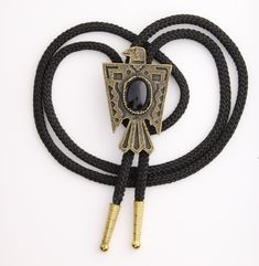 "Thunderbird Phoenix Bolo Tie with black stone, antique gold, Choose Black or Red 35\" Cord, 56mm, Each 57mm pendant Made in USA You choose black or red 36\" cord. handmade jewelry" Black Vintage Oxidized Jewelry, Vintage Oxidized Black Jewelry, Vintage Black Bolo Ties For Gift, Vintage Black Bolo Ties As Gift, Vintage Black Jewelry With Antique Finish, Antique Black Brass Necklace, Adjustable Western Gold Jewelry, Adjustable Gold Western Jewelry, Vintage Black Brass Jewelry