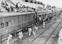 an old black and white photo of people standing on the side of a train as it passes by