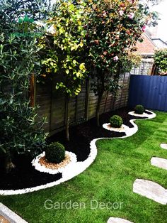 an outdoor garden with grass and stepping stones