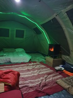 a bed in a tent with green lights